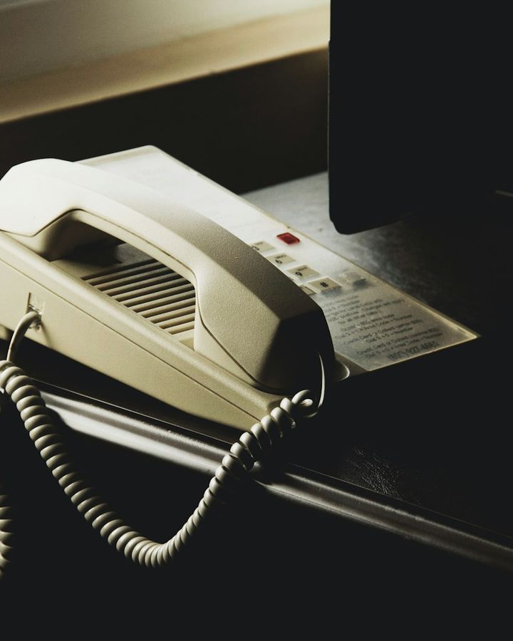 White desk phone with a coiled cord