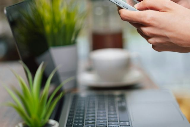 Person using a phone at a café table