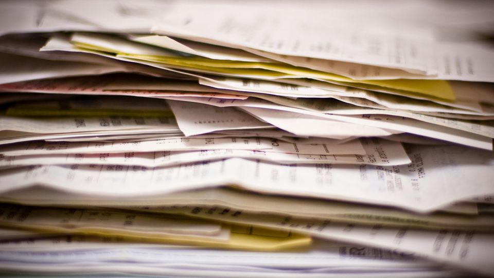 Deep stack of paperwork and forms