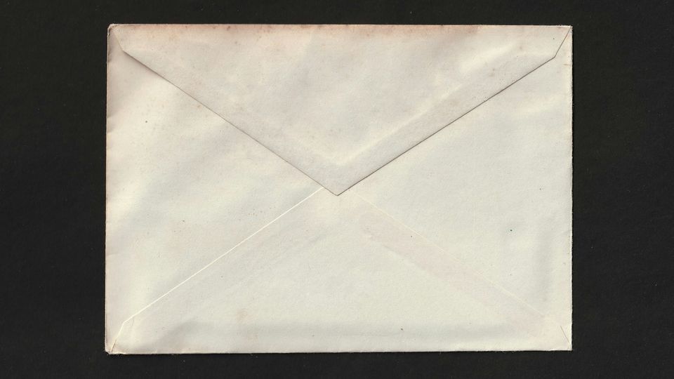 Plain white envelope on a black background