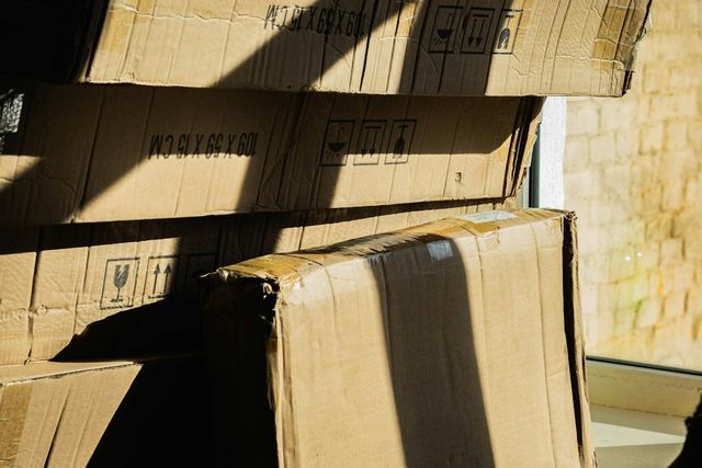 Stack of cardboard boxes by a sunlit window
